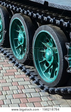 A Military Vehicle On Caterpillar Tracks Stands On A Square Of Paving Stones. Photo Of Green Caterpi