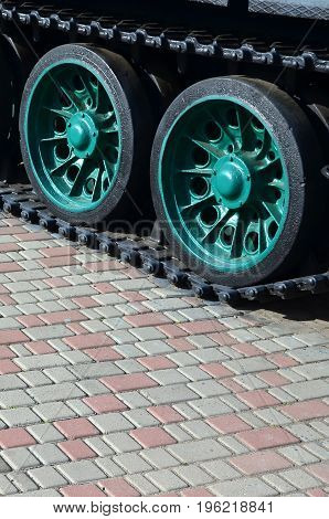 A Military Vehicle On Caterpillar Tracks Stands On A Square Of Paving Stones. Photo Of Green Caterpi