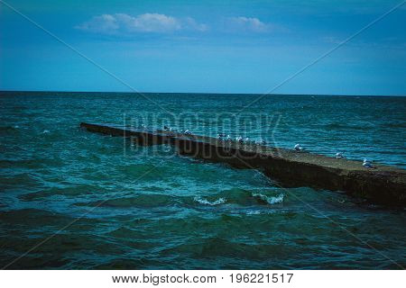 Stone pier reaching out onto Lake Erie.