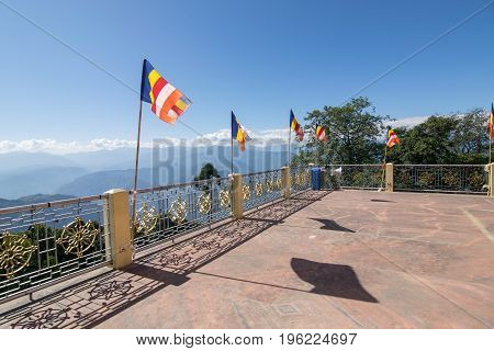 Colourful Buddhist Prayer flags are waving in strong wind under sunshine at Samdruptse huge buddhist memorial Monastery in Sikkim India.