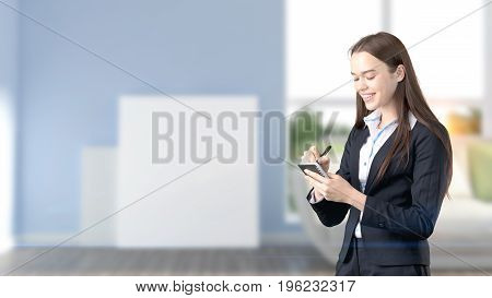 Young Beautiful Business Woman And Creative Designer Standing Over Blured Interior Background