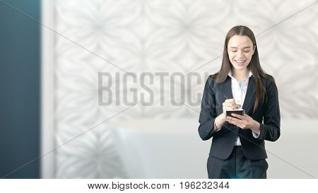 Young Beautiful Business Woman And Creative Designer Standing Over Blured Interior Background