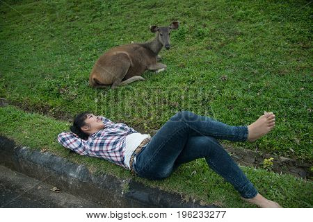 Beautiful smiling Asian woman lying down and emulate deer.
