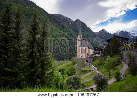 Heiligenblut with St Vincent Church in the background the beautiful Grossglockner. Beautiful sunny summer day in Austria.