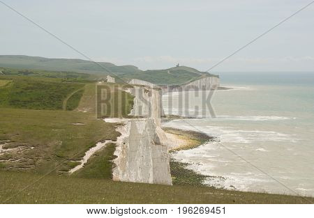 View along the Seven Sisters chalk cliffs from Cuckmere Haven near Eastbourne East Sussex England. Beachy Head in distance.