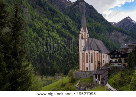 Heiligenblut with St Vincent Church in the background the beautiful Grossglockner. Beautiful sunny summer day in Austria.