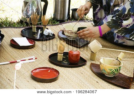 Japanese Women Making Sado Chanoyu Or Japanese Tea Ceremony, Also Called The Way Of Tea At Outdoor