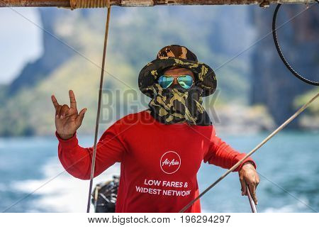 Krani Thailand March 09 2016: Portrait of a man sailing a long tail boat in Thailand.