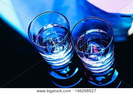 drinking glasses with ice close-up on a dark background.