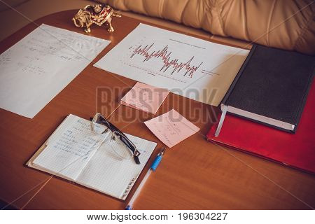 Work in the office with paper graphics and data