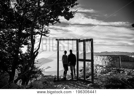 A loving couple hold hands and look forward to the future black and white