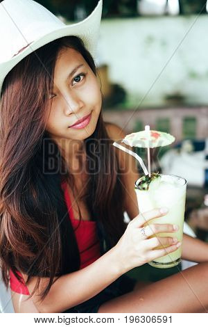 Young Beautiful Woman Drinking Cocktail With Pineapple In Beach Bar