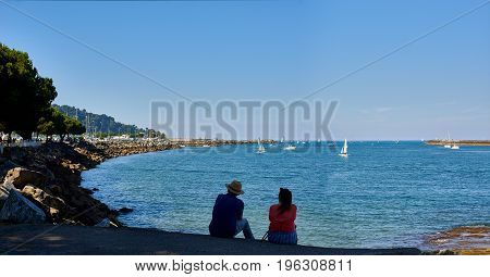 Hondarribia Spain - July 16 2017. People in front of Txingudi bay at the mouth of the Bidasoa river in Hondarribia (Fuenterrabia). Gipuzkoa Basque country Spain.