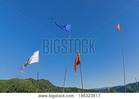 Colurful Buddhist Prayer flags are waving in strong wind under sunshine at Samdruptse huge buddhist memorial Monastery in Sikkim India.