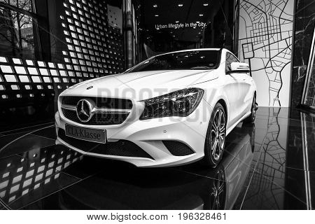 BERLIN - JANUARY 24 2015: Showroom. Compact executive car Mercedes-Benz CLA200. Black and white. Produced since 2013.