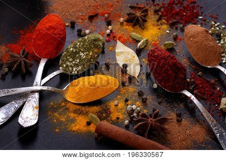 Bright spices on an old wooden board