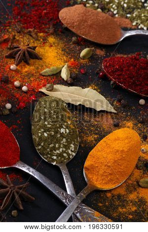 Bright spices on an old wooden board