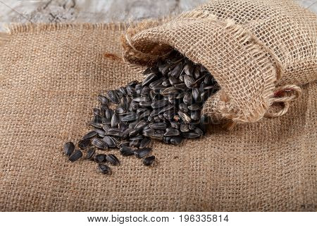 Sunflower seeds in a sack on burlap. Close-up
