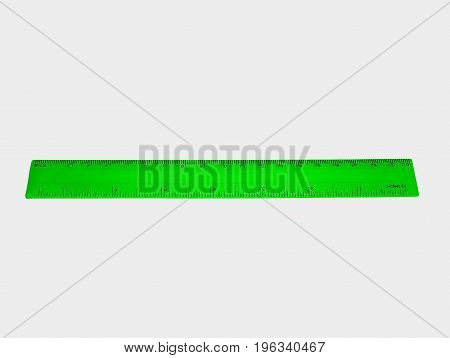 Student green ruler with numbers isolated on white background.