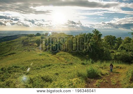 Overview of people walking through fields and hills in the sunset near the town of Frascati, a pleasant and well known place for its fine wines, near Rome. Located in the Lazio region, central Italy