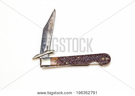 Worn Jack knife with the blade partially open on a white background