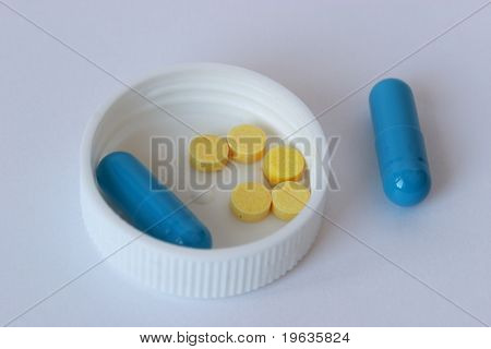 Blue and yellow tablets on a white background
