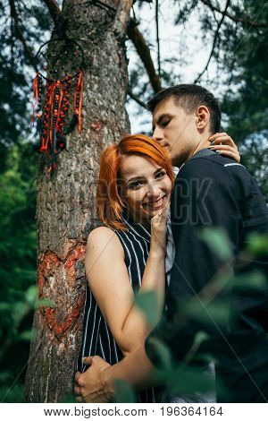 Love couple kissing under a tree, dreamcatcher on the tree