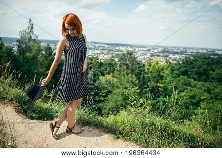 pretty gignger girl portrait on the peak of the hill