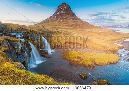 Kirkjufell volcano with watefall beautiful winter natural landscape background