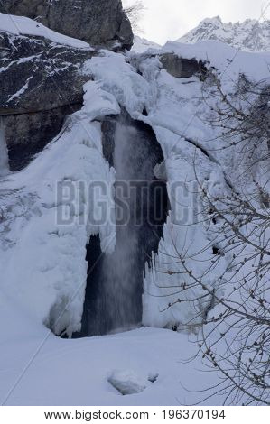 small waterfall in formazza valley during winter