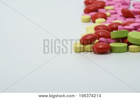 Colorful of vitamin tablets on white background