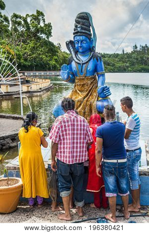Grand Bassin Mauritius - December 26 2017: Group of people praying at Grand Bassin temple on December 29 2014 in Mauritius. It is considered the most sacred Hindu place in Mauritius.