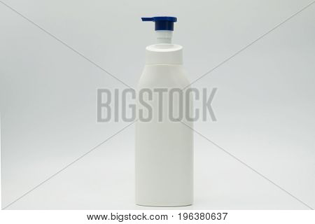 Cosmetic bottle with blue pump isolated on white background