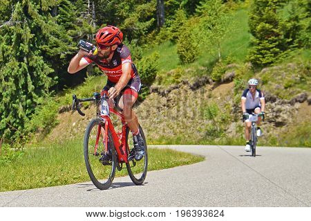Muntele Mic Romania - June 10: Two athletes competing in the Muntele Mic Vertical Race road cycling cometition. Shot taken on June 10th 2017