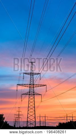 silhouette engineer repair and electrical installation work on high voltage pylons over
