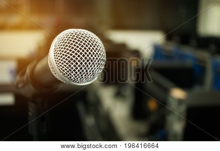 Microphone on abstract blurred of speech in seminar room or speaking conference hall light computer bokeh background