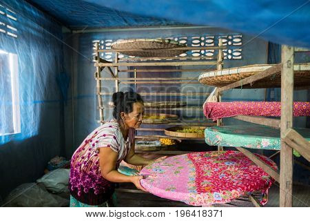 villagers of Ban Sanuan Nok Buriram Province. Thailand - April 30 2017: old women activists are presenting silkworms in farm.traditional thai fabric at Burirum Thailand. The local silk cloth is characterised by elaborate patterns and design
