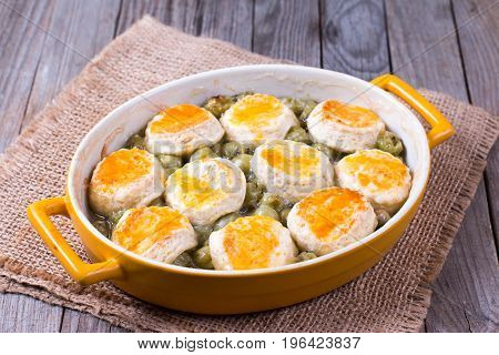 homemade cramble (cobbler) in ceramic form on a wooden background