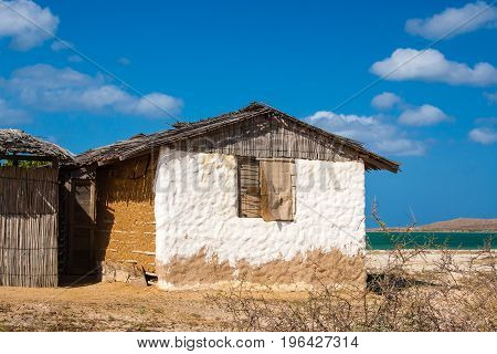 Traditional Adobe House Next To The Sea Under Blue Sky