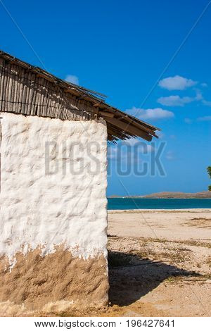 Traditional Adobe House Next To The Sea Under Blue Sky