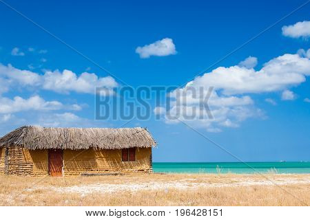 Colorful adobe house next to the sea under blue sky