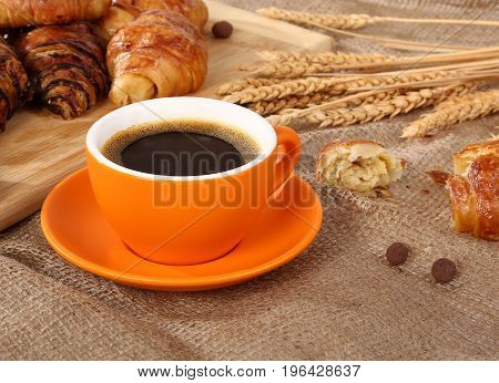Morning cup of  hot coffee and croissant.
