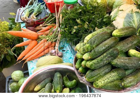 Fresh vegetables and herbs on the counter in the market. Close-up.