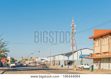 KEETMANSHOOP NAMIBIA - JUNE 13 2017: A late afternoon view of Keetmanshoop with businesses a microwave telecommunications tower and vehicles visible