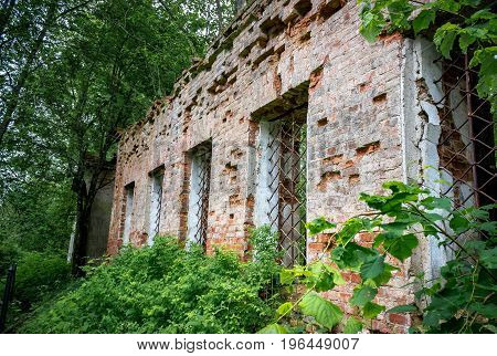 Wall with windows of the ruined temple of St. Nicholas in the village of Gribny. Russia, Tver region.