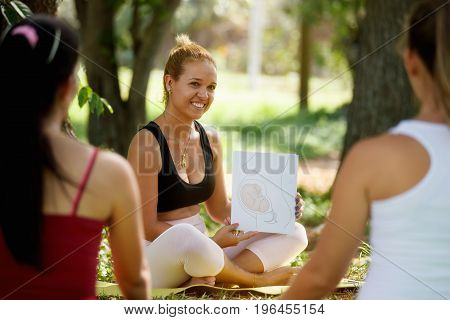 Antenatal Class With Doctor And Pregnant Women In Park
