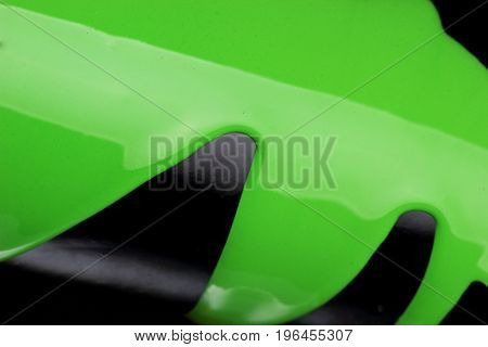 Pouring Green Paint Over Black Background, Macro Closeup.texture.abstract