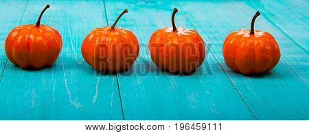 A Close Up Of Several Small Pumpkins Lined Up In A Row On Rustic Old Wooden Boards Against Medium Br