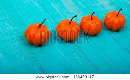 A Close Up Of Several Small Pumpkins Lined Up In A Row On Rustic Old Wooden Boards Against Medium Br