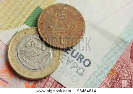 Greek Drachma and euro coin on bank note